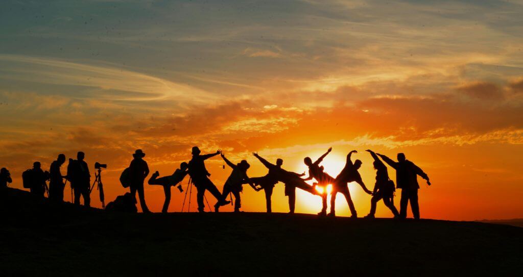 pexels-photo-207896-207896 Group of people silhouetted against a vibrant sunset, showcasing unity and joy.