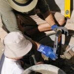 A father and young son check the last details before beginning a hands-on family project to build an umbrella base.