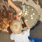 Decorating With Intention — Mother and Son Press Shells Into the Concrete Base